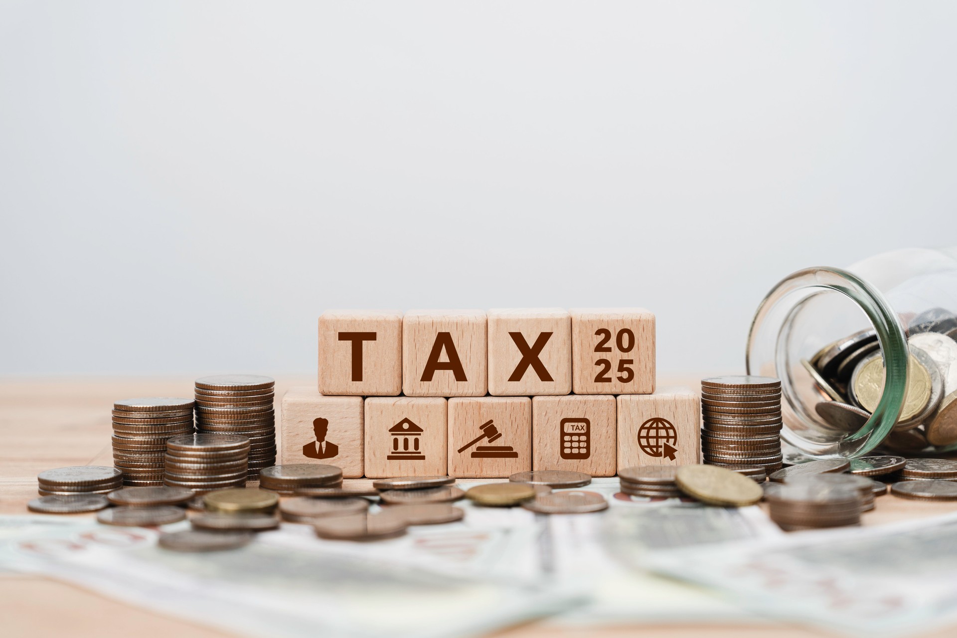 Tax planning 2025 concept with icons on wooden blocks Tax reduction, Individual income return to Government. paperwork, financial research, report. Calculation tax return