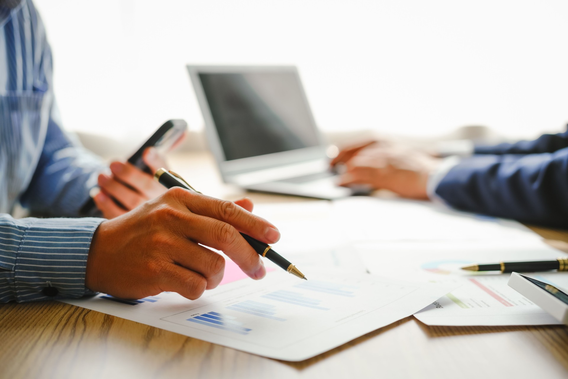 Desk-bound businessman calculates figures, verified accounts, and collaborates in discussions. Proficient in using calculators, aiding each other, and managing annual tax accounts in the audit office